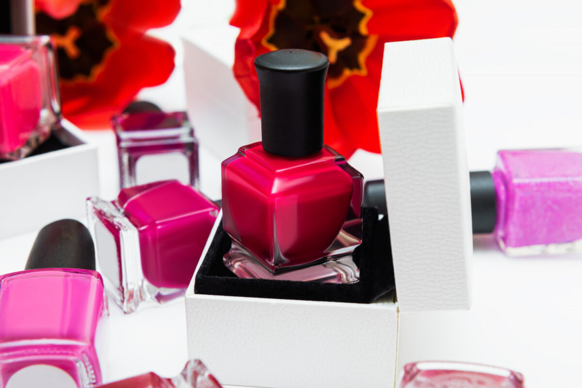 Assorted bottles of hypoallergenic nail polish in soft shades arranged on a clean surface, safe for sensitive nails